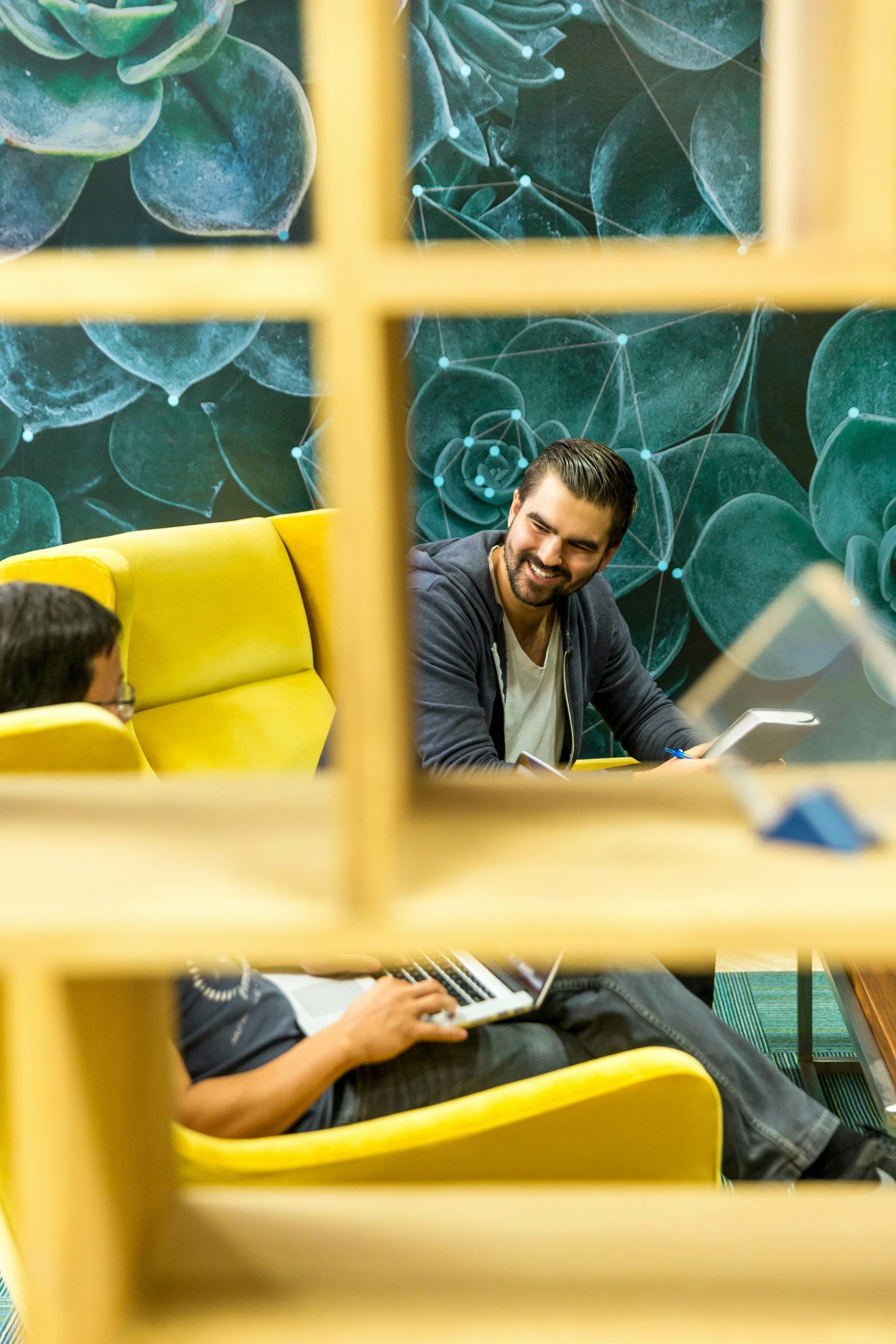 Office workers talking in a lounge setting